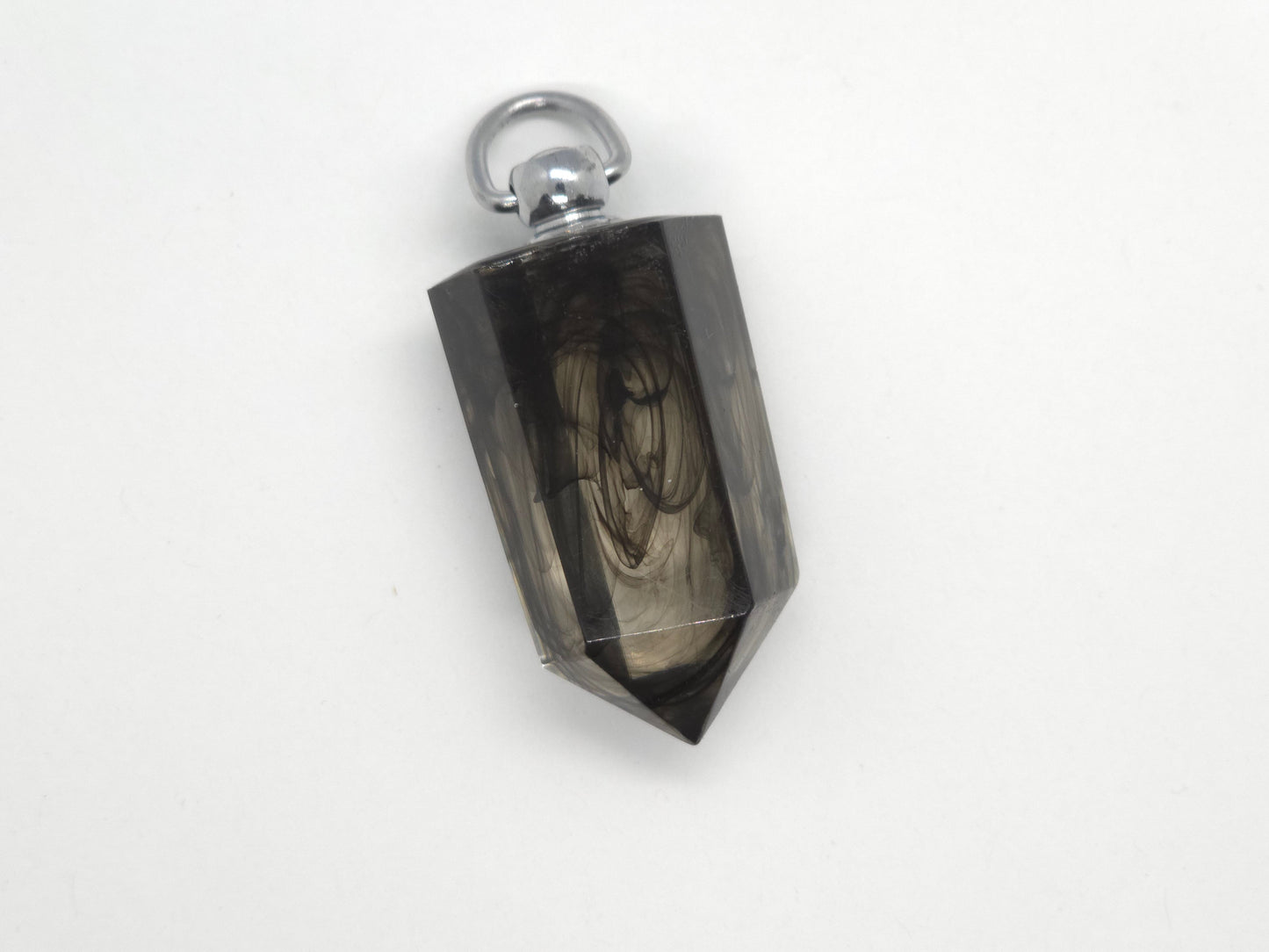 Black crystal pendant with silver top on a white background