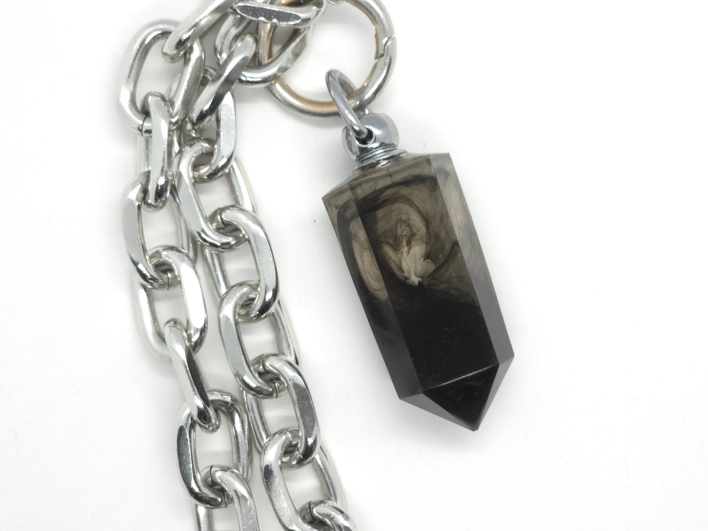 Silver chain necklace with a black crystal like pendant